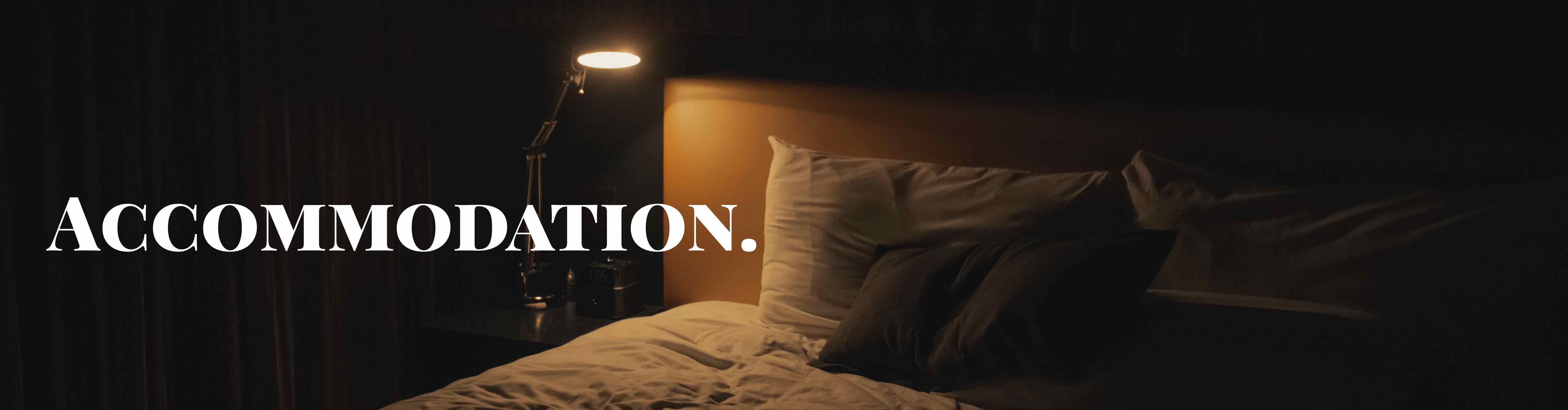 bedside lamp illuminating a bed